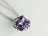 an amethorate ring with a purple stone in the middle of it