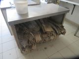 a metal table with a bunch of bags on top of it