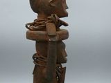 an old wooden statue of a person with a helmet on it ' s head