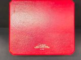 a red box with a gold logo on it sitting on top of a table