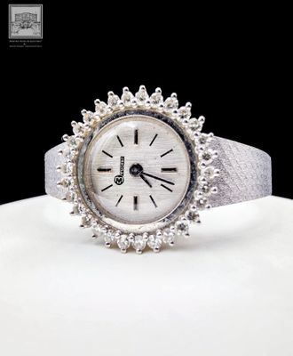 an image of a close up of a wrist watch on a white surface