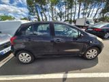 a small black car parked in a parking lot