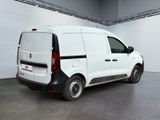 the back of a white van parked in a large room