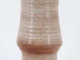 the vase is made out of clay and has a brown glaze