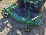a green lawn mower that is sitting in the grass