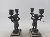 pair of antique bronze figurines of a boy and a girl on marble bases