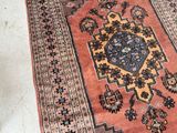 a rug on the floor with a cat sitting on it