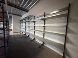 many empty shelves in a warehouse with no one on them