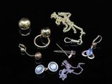 many different types of jewelry on a black surface