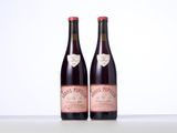two bottles of wine sitting on top of a table