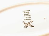 an image of a plate with a bird on it on a table
