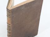 a book that is sitting on a white surface