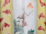 a vase with a painting on it sitting on a table