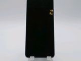 a black cell phone sitting on top of a silver stand