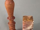 a small wooden object next to a small wooden object