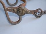 a pair of scissors on a table with a chain around it