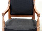 a black chair with a wooden frame and a black seat