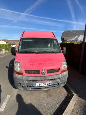 a pink van that is parked on the side of the road