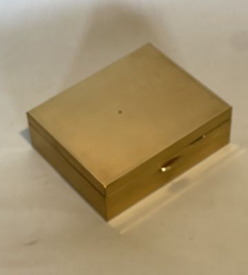 a gold box sitting on a white surface