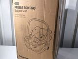 the box of the baby car seat is open and ready to be used