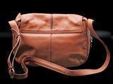 leather cross body bag on a black background