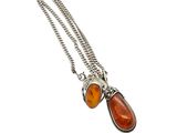 a close up of a necklace on a white background