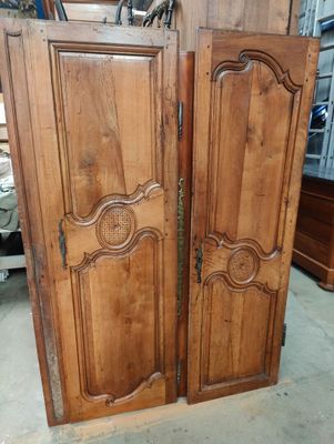 pair of antique french doors with carved wood panels
