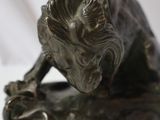 bronze statue of a lion on a white background