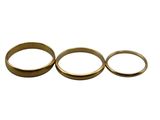 three gold wedding rings on a white background