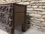 an old wooden chest sitting in front of a stone wall