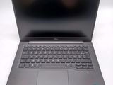 a close up of a laptop with a keyboard on a white surface