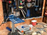a workbench with a drillet and other tools on it