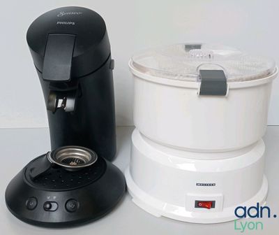 a coffee maker next to a blender on a counter