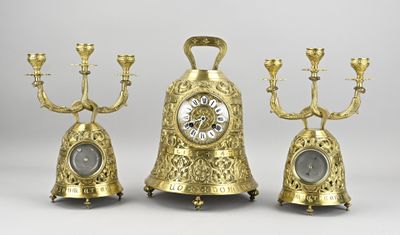 three gold colored clocks sitting next to each other
