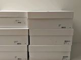 several white boxes stacked on top of each other on a table