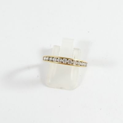 a close up of a gold ring with diamonds on a white background