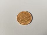 a close up of a gold coin on a white surface