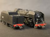 two toy trains sitting next to each other on a table