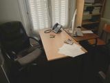 a desk with a chair and a computer on it