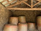 hay bales are stacked up in a barn with a roof