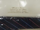 a black tie with red and blue stripes on it