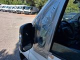 many cars parked in a parking lot with a tarp covering them