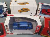 several toy cars are sitting in boxes on a table