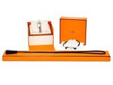 an orange box with a watch and a black strap