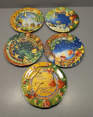 six decorative plates with different designs on them sitting on a table