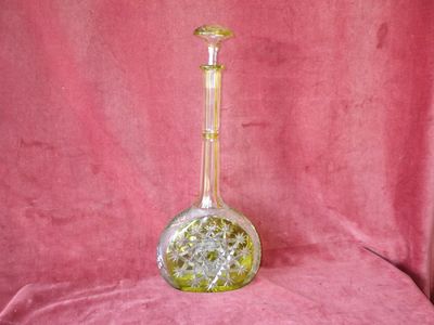 a glass vase that is sitting on a pink cloth