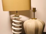 a lamp that is next to a vase on a table