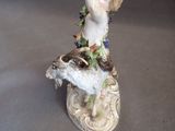 porcelain figurine of a boy with a bird on his shoulder