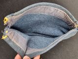 someone is holding a small purse with a zipper in it