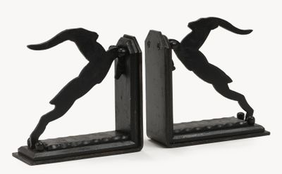 two bookends that have a silhouette of a man and a dog on them